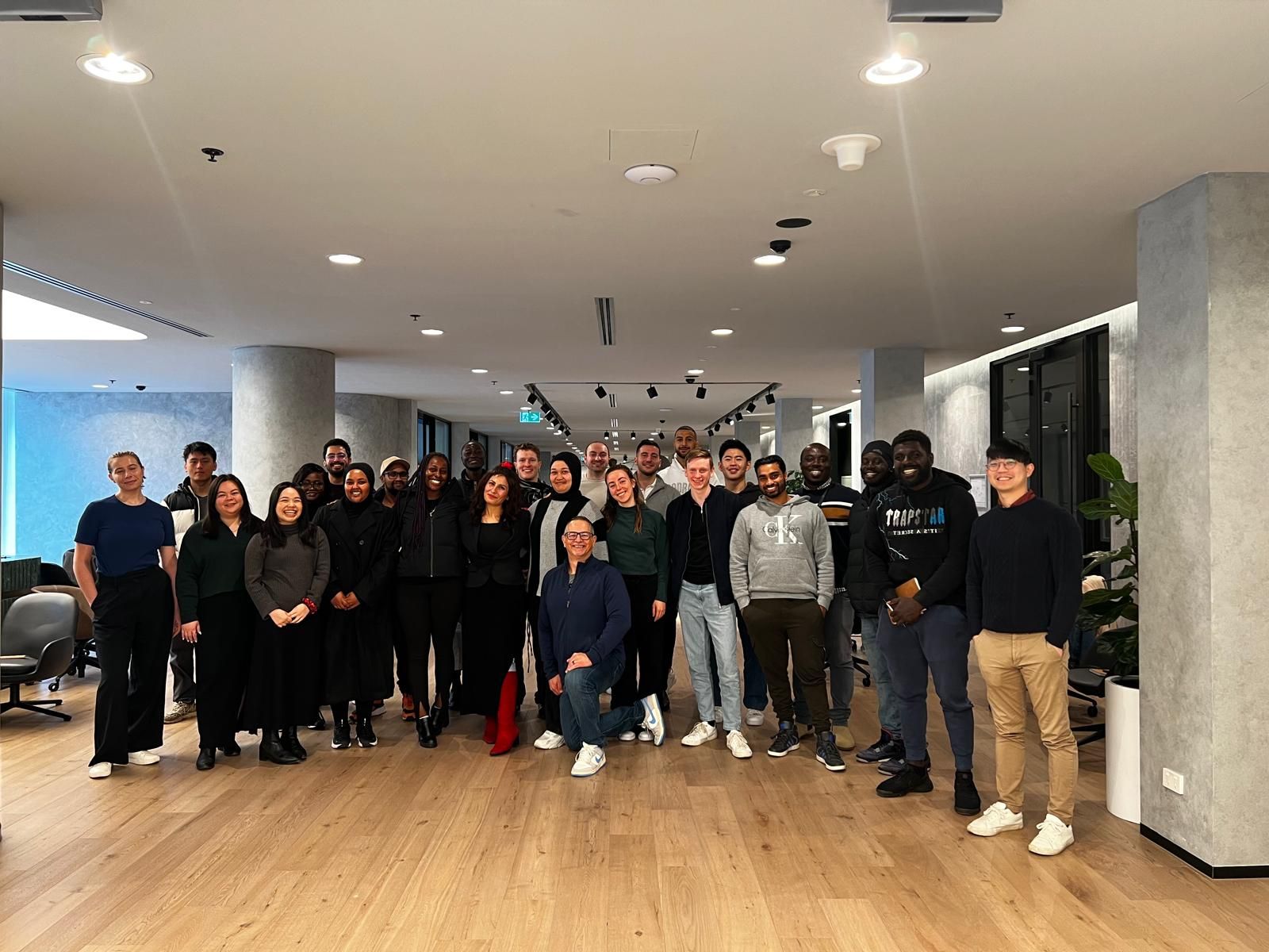 A program cohort gathered in an office